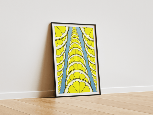 Framed abstract art with lemons on a white wall.