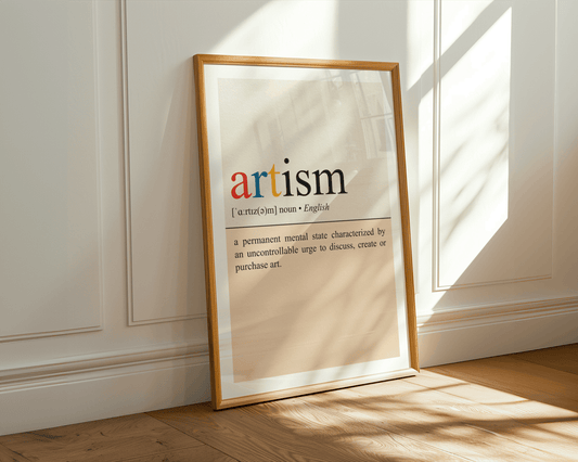 Framed artwork with the word 'artism' on a wall with sunlight casting shadows.