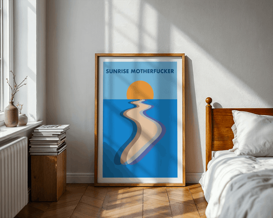 Framed artwork with a sunrise and 'SUNRISE MOTHERFUCKER' text in a bedroom setting