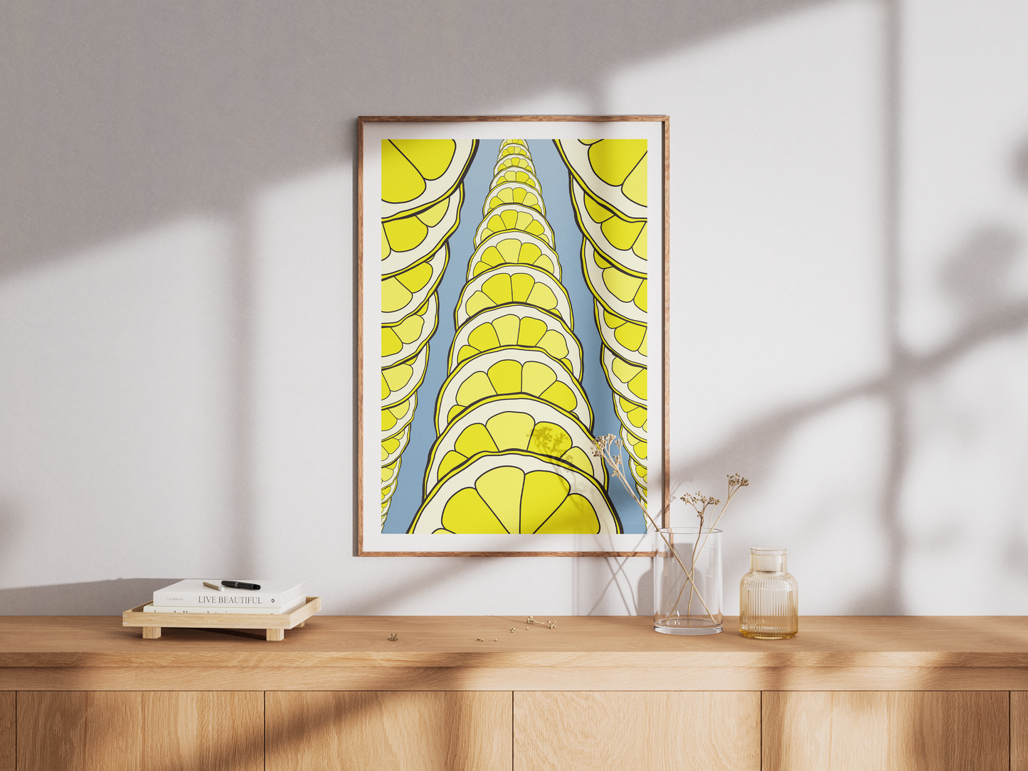 Framed artwork with lemon slices design on a wooden surface.