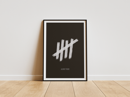 Framed poster with a tally mark symbol on a black background against a white wall.