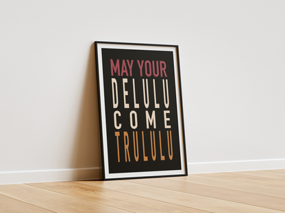 Framed poster with text 'May your DELULU come TRULULU' on a white wall.