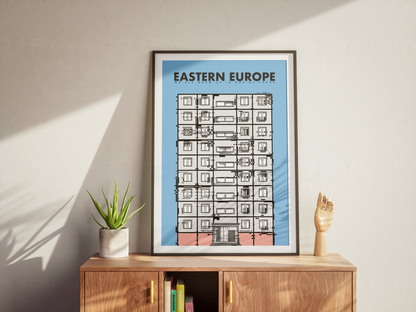 Framed poster titled 'Eastern Europe' on a wooden cabinet with a plant and small sculpture.