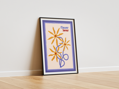 Framed artwork with floral design and text 'Flower Lover' on a white wall.