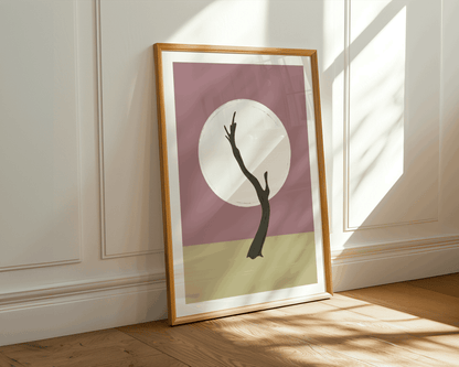 Framed artwork with a minimalist design of a Namibian tree silhouette against a moon on a beige background, leaning against a wall.