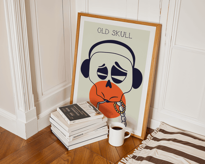 Framed artwork of a 'Old Skull' with books and a mug on a wooden floor.