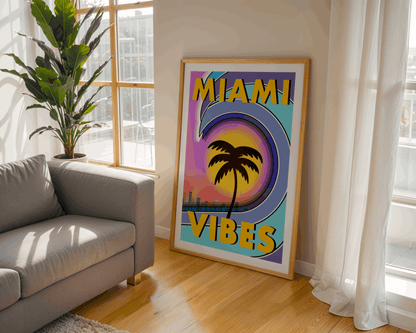 Framed 'Miami Vibes' poster in a living room with a couch and plant.