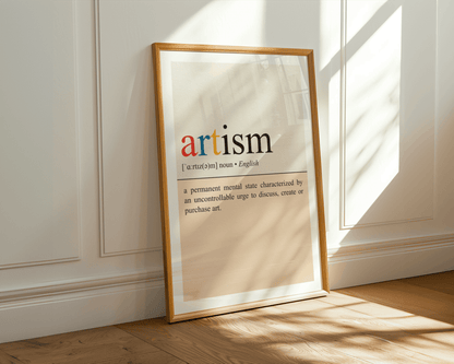 Framed artwork with the word 'artism' on a wall with sunlight casting shadows.