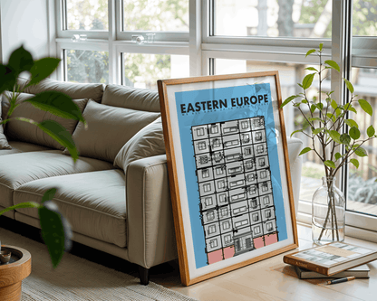 Framed art print of Eastern Europe on a table with a couch and plants in the background