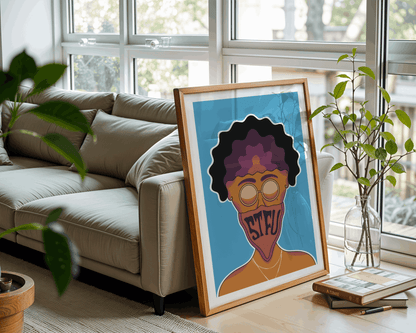Framed artwork of a person with text on a blue background in a living room.