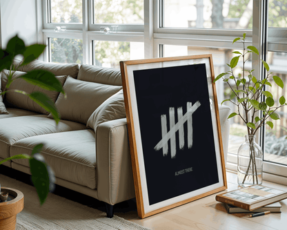 Framed artwork with tally marks design on a coffee table in a living room.