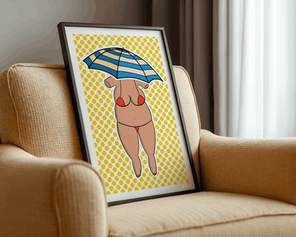 Framed artwork of a woman with a striped umbrella on a beach with a yellow patterned background, leaning against a beige armchair.