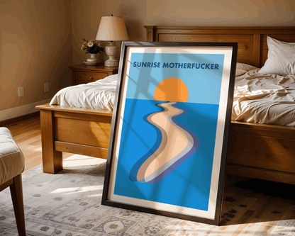 Framed artwork with a beach scene and 'SUNRISE MOTHERFUCKER' text in a bedroom setting