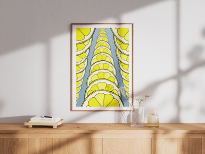 Framed artwork with lemon slices design on a wooden surface.
